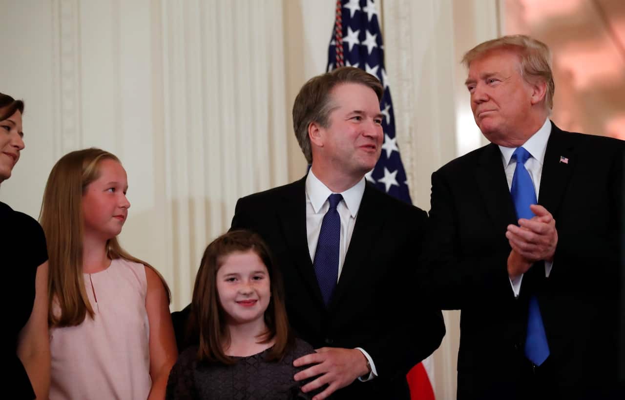 President Donald Trump talks with Judge Brett Kavanaugh his Supreme Court nominee