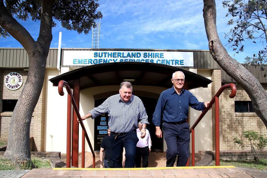 Member for Hughes Craig Kelly and Prime Minister Malcolm Turnbull leave after a bushfire briefing and press conference at Heathcote Fire Control Centre in Sydney, Sunday, April 15, 2018. (AAP Image/Jeremy Ng) NO ARCHIVING