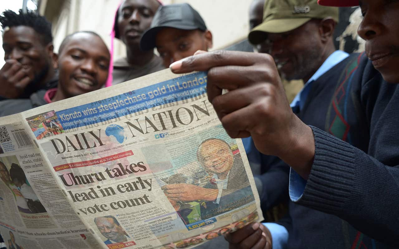 A group of men read a local newspaper on August 9, 2017 in Kiambu, north of Nairobi, a day after the presidential election.