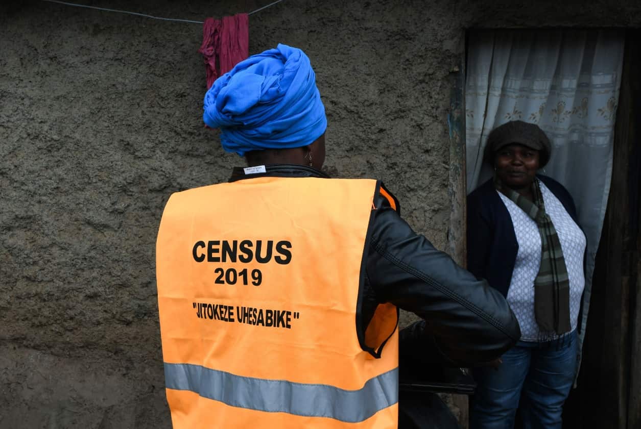 Peninah Ayolo (R) welcomes a worker of the Census enumeration, August 24, 2019 in Nairobi, during the population census. 