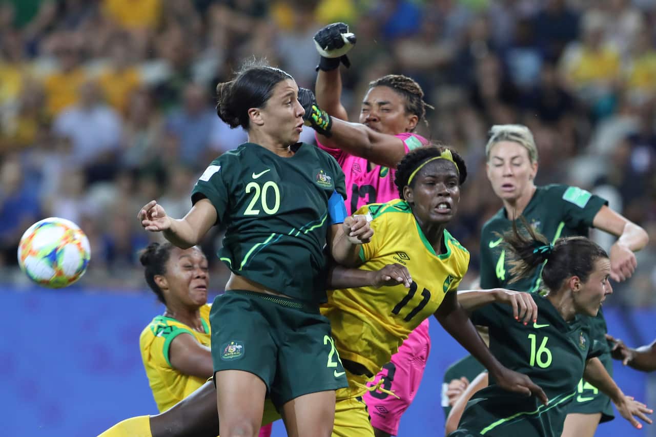 Kerr, top left, fights for the ball with Jamaica's Khadija Shaw, center, and Jamaica goalkeeper Nicole McClure.