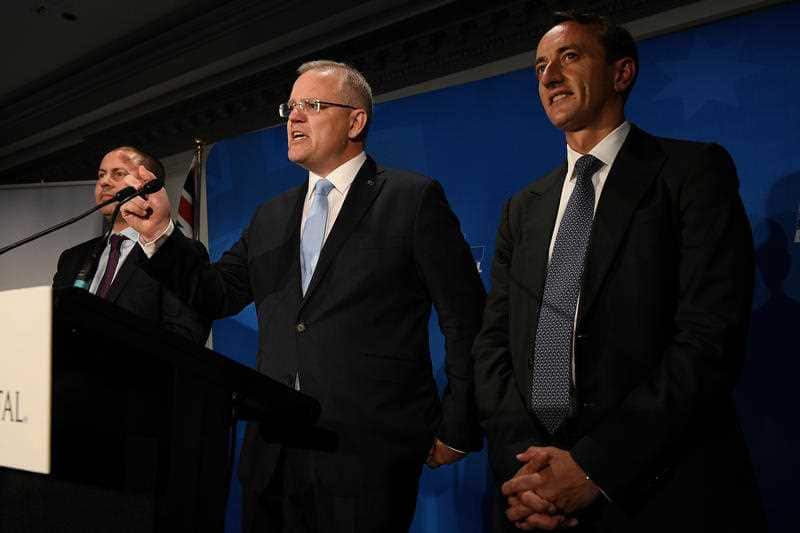 "A rough day": The Morrison government now faces a minority parliament. Mr Morrison with   Liberal candidate Dave Sharma.
