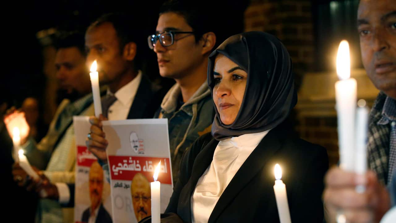 Activists, protesting the killing of Saudi journalist Jamal Khashoggi, hold a candlelight vigil outside Saudi Arabia's consulate in Istanbul.