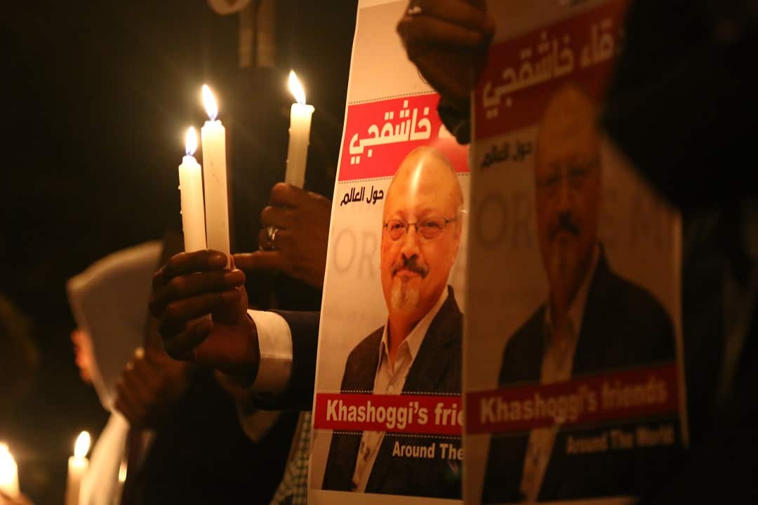 Activists, protesting the killing of Saudi journalist Jamal Khashoggi, hold a candlelight vigil outside Saudi Arabia's consulate in Istanbul.