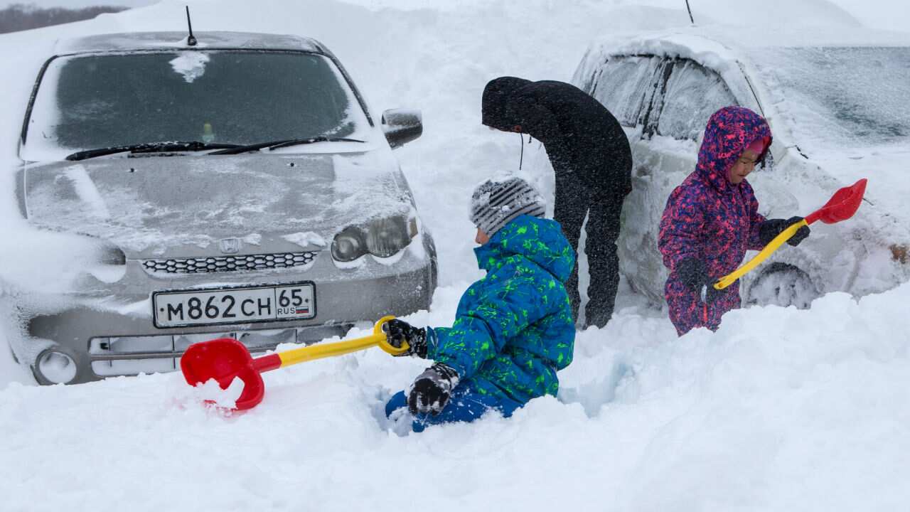 Kids play in the snow after a snowfall in the Dalneye region of Yuzhno-Sakhalinsk.