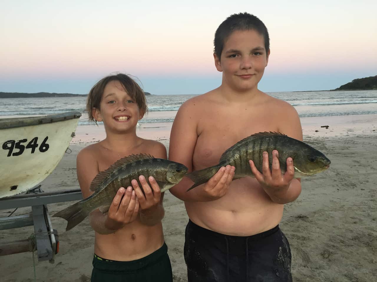 indigenous children holding fish