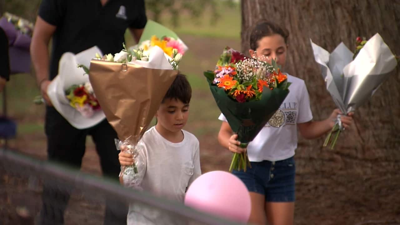 More flowers are added to a memorial for the four children killed in a Sydney car crash.