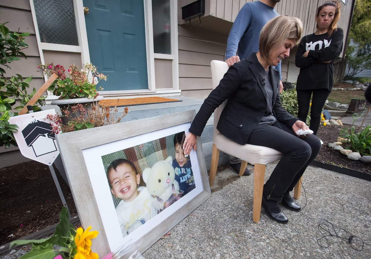 Tima Kurdi, touches a photo of her nephews Alan and Galib Kurdi while speaking to the media outside her home in Coquitlam, B.C., on Thursday, Sept. 3, 2015.