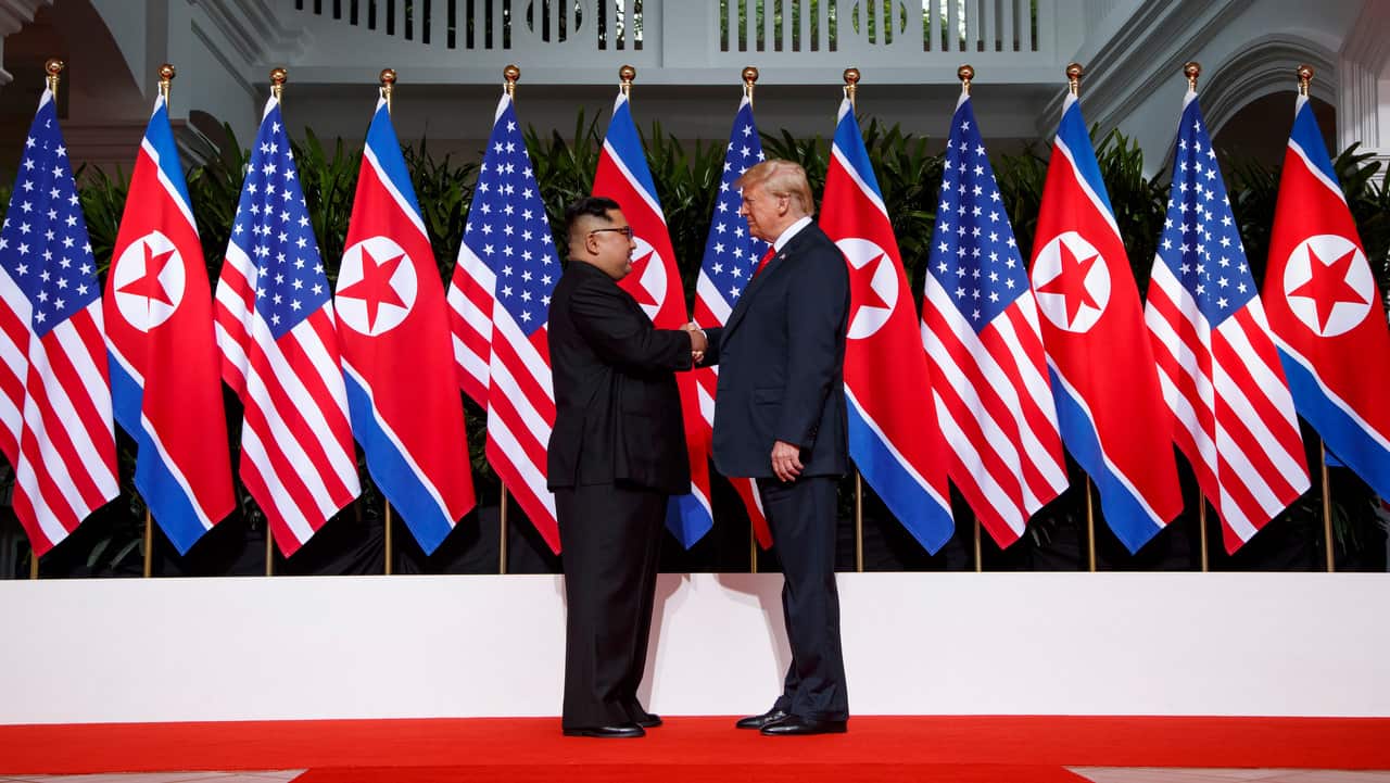 US President Donald Trump shakes hands as he meets with North Korean leader Kim Jong Un on Sentosa Island, in Singapore.  