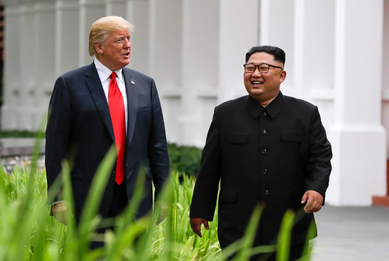 US President Donald Trump and North Korea leader Kim Jong Un walk from their lunch at the Capella resort on Sentosa Island in Singapore on 12/6/18.