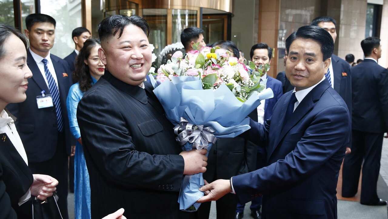 North Korean leader Kim Jong Un poses for a photograph with with Chairman of the Hanoi People's Committee Nguyen Duc Chung.