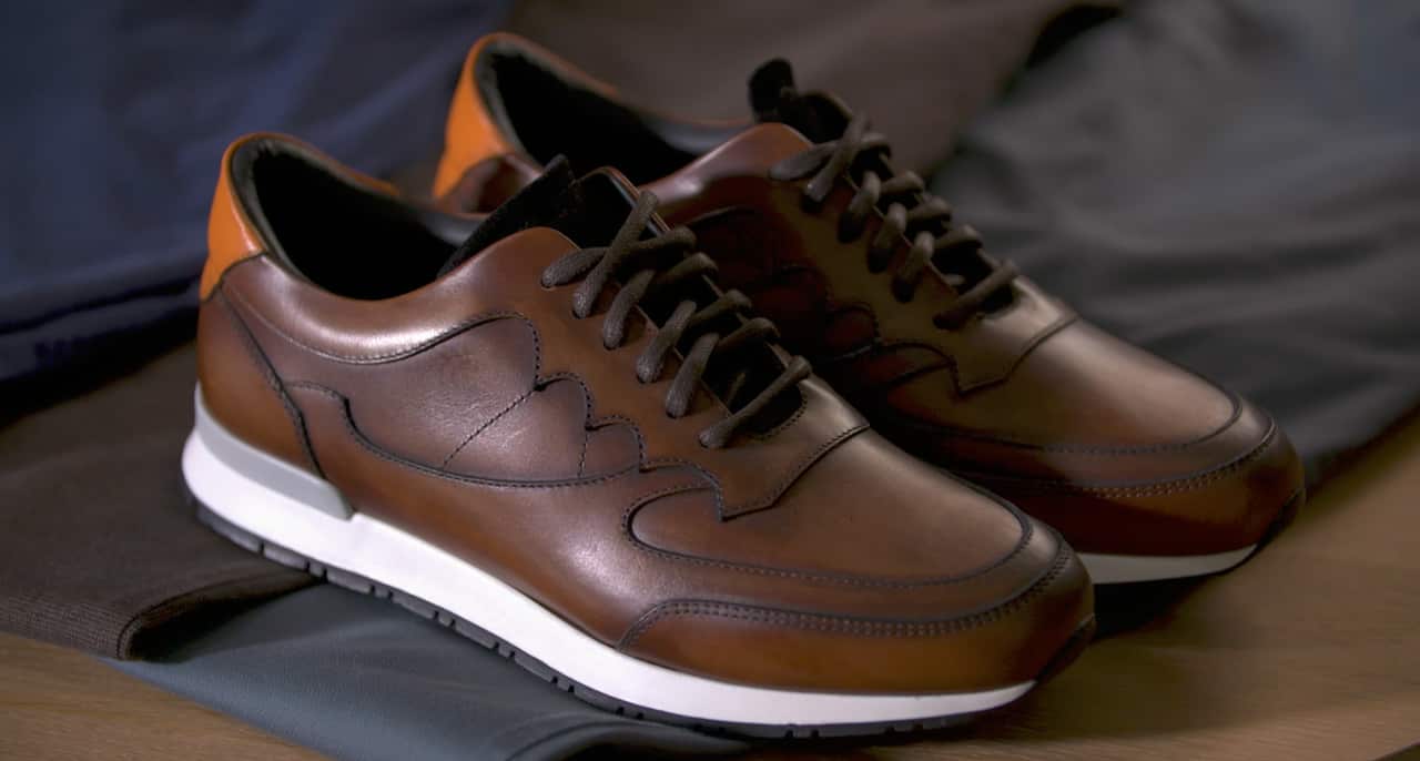 Christian Kimber uses recycled rubber and hand painted designs on some of his shoes.