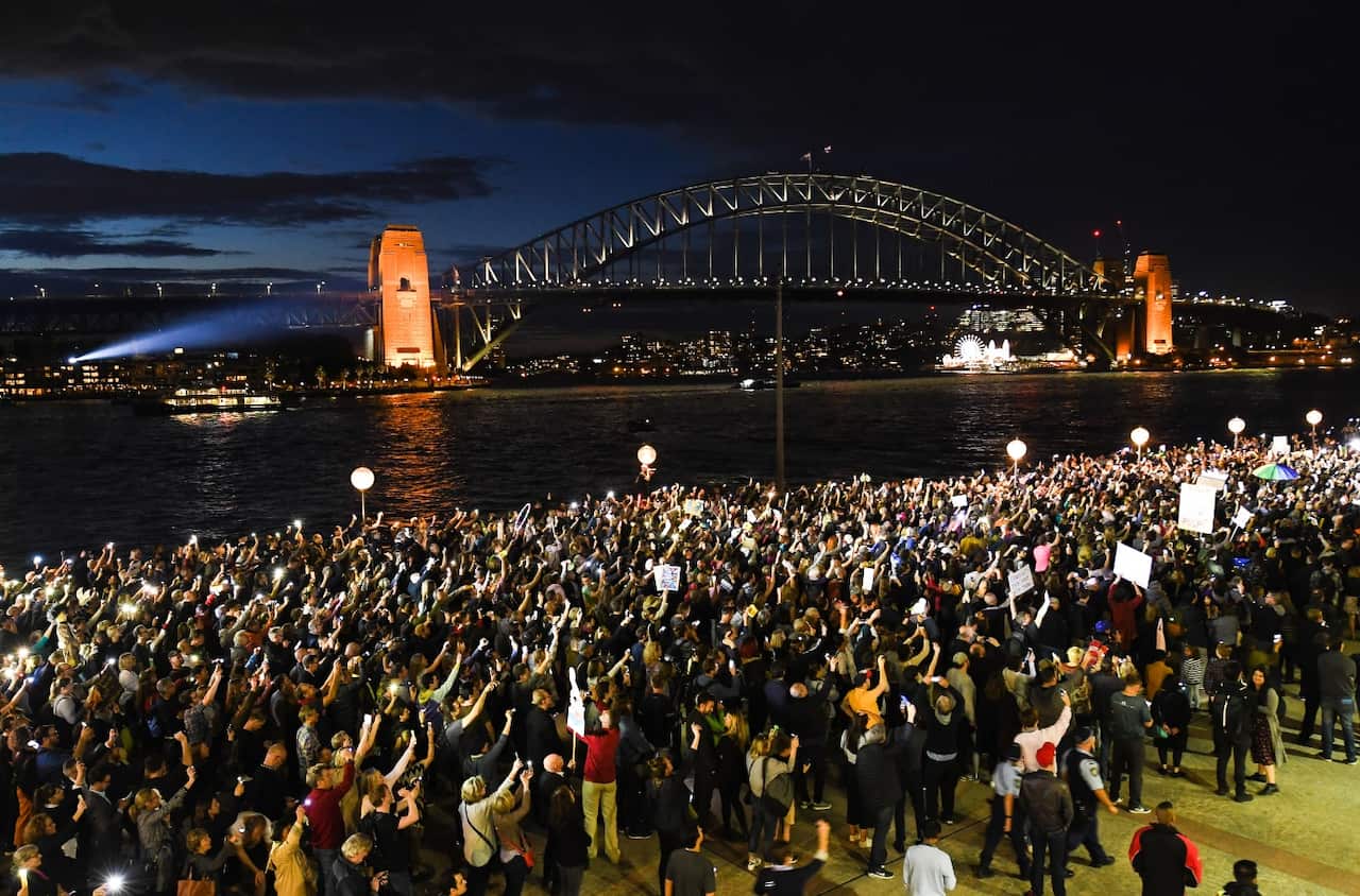 Demonstrators are seen protesting against the decision to project the barrier draw results for NSW Racing's multi million dollar race