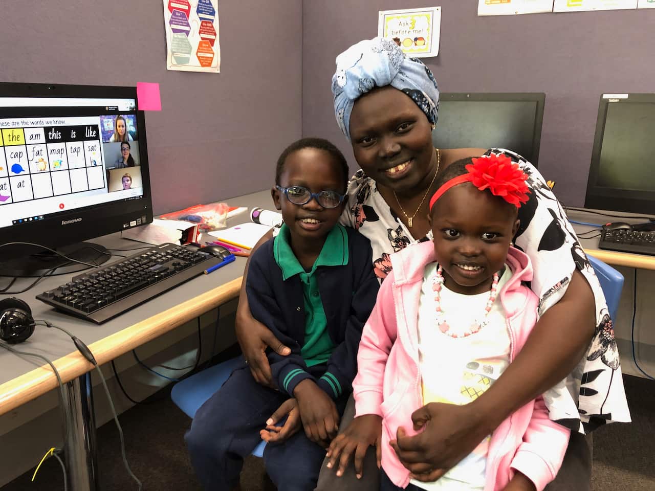 Student Kondial, mum Nyatoang PinYien and sister Nyapuot watch a remote learning class