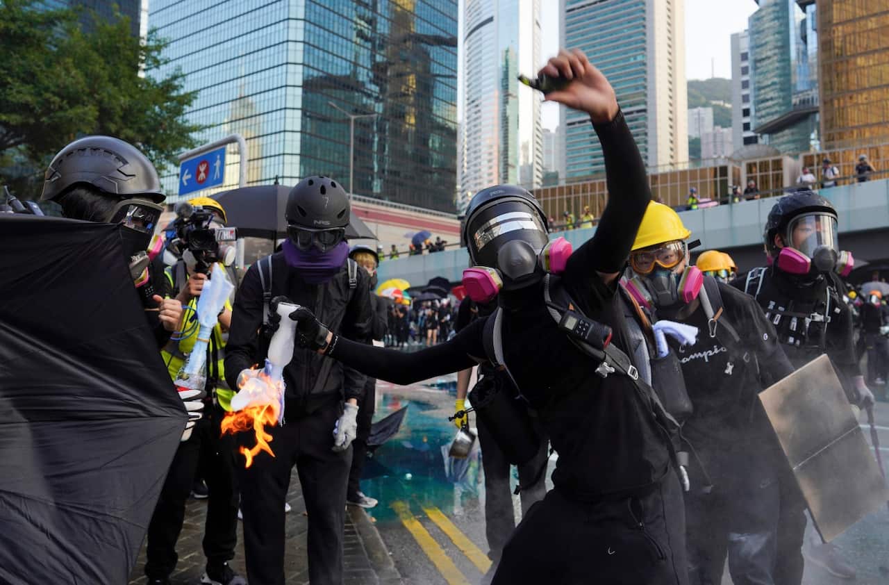 An anti-government protester throws a Molotov cocktail during a demonstration near Central Government Complex in Hong Kong, Sunday, Sept. 15, 2019. 