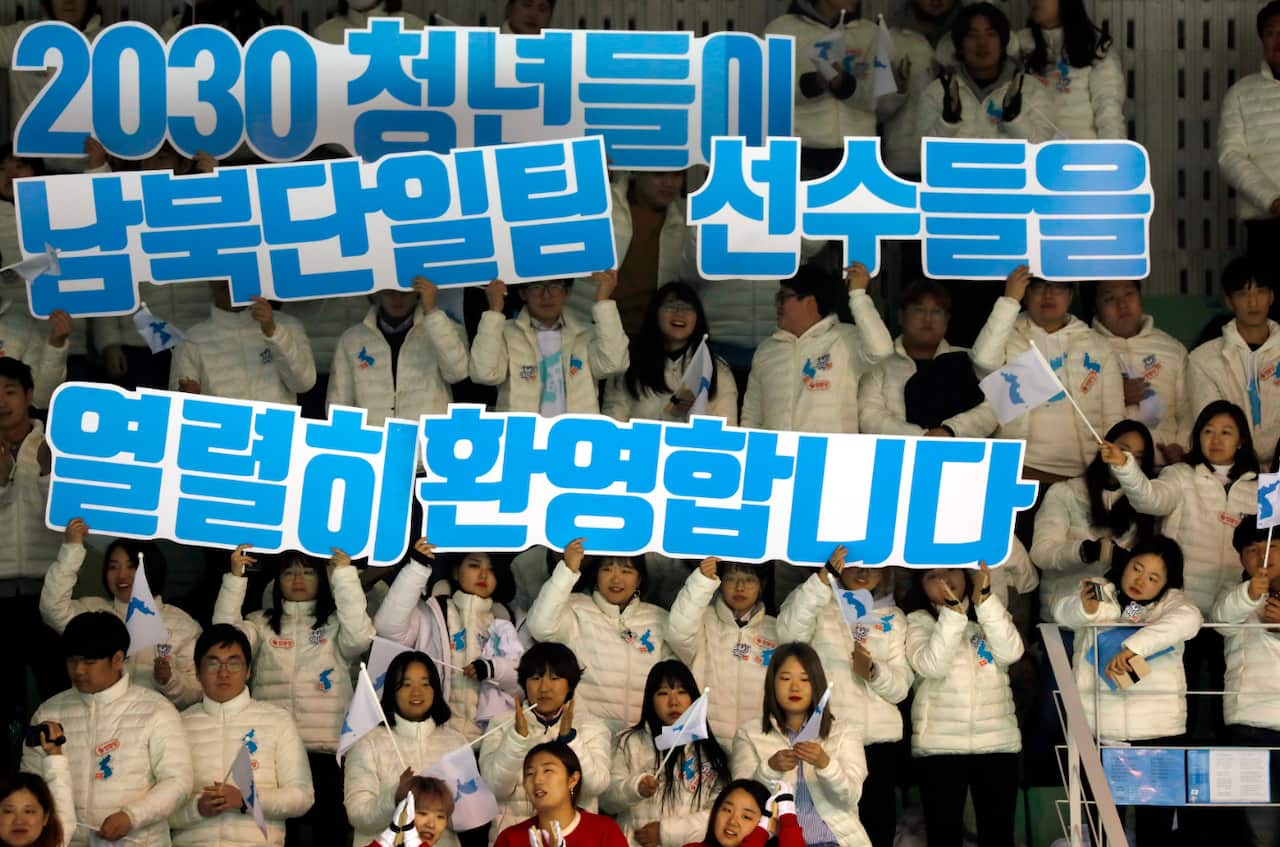 Fans hold a sign reading 'The young 20-30s welcome Team Korea' during the Women's Ice Hockey friendly match.