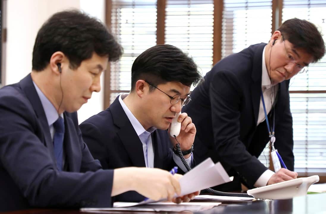 South Korean officials on the phone with their North Korean counterparts test the hotline.