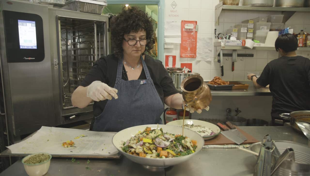 Dena Miller cooking in the kitchen 