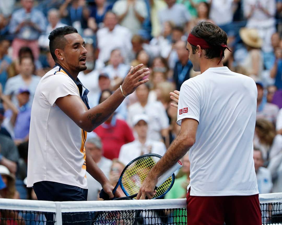 Roger Federer, right, of Switzerland, shakes hands with Nick Kyrgios, of Australia, after Federer defeated Kyrgios during the third round of the U.S. Open tennis tournament, Saturday, Sept. 1, 2018, in New York. (AP Photo/Jason DeCrow)