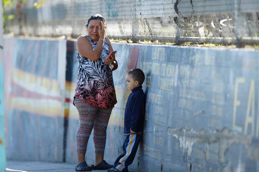 A worried parent awaits news about her son, an eight grader at the school, after the shooting.