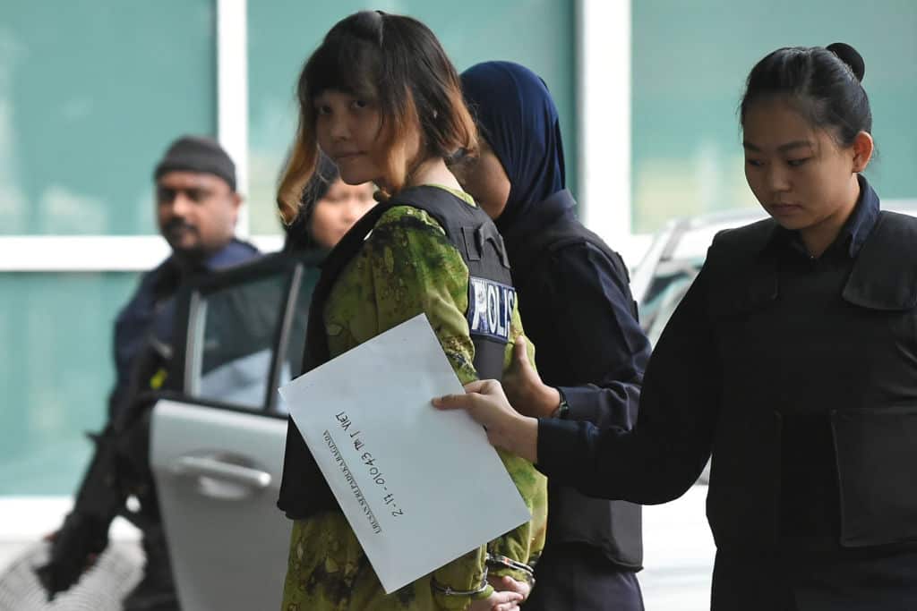 Vietnamese defendant Doan Thi Huong is escorted by police personnel following her arrival at the Malaysian Chemistry Department.