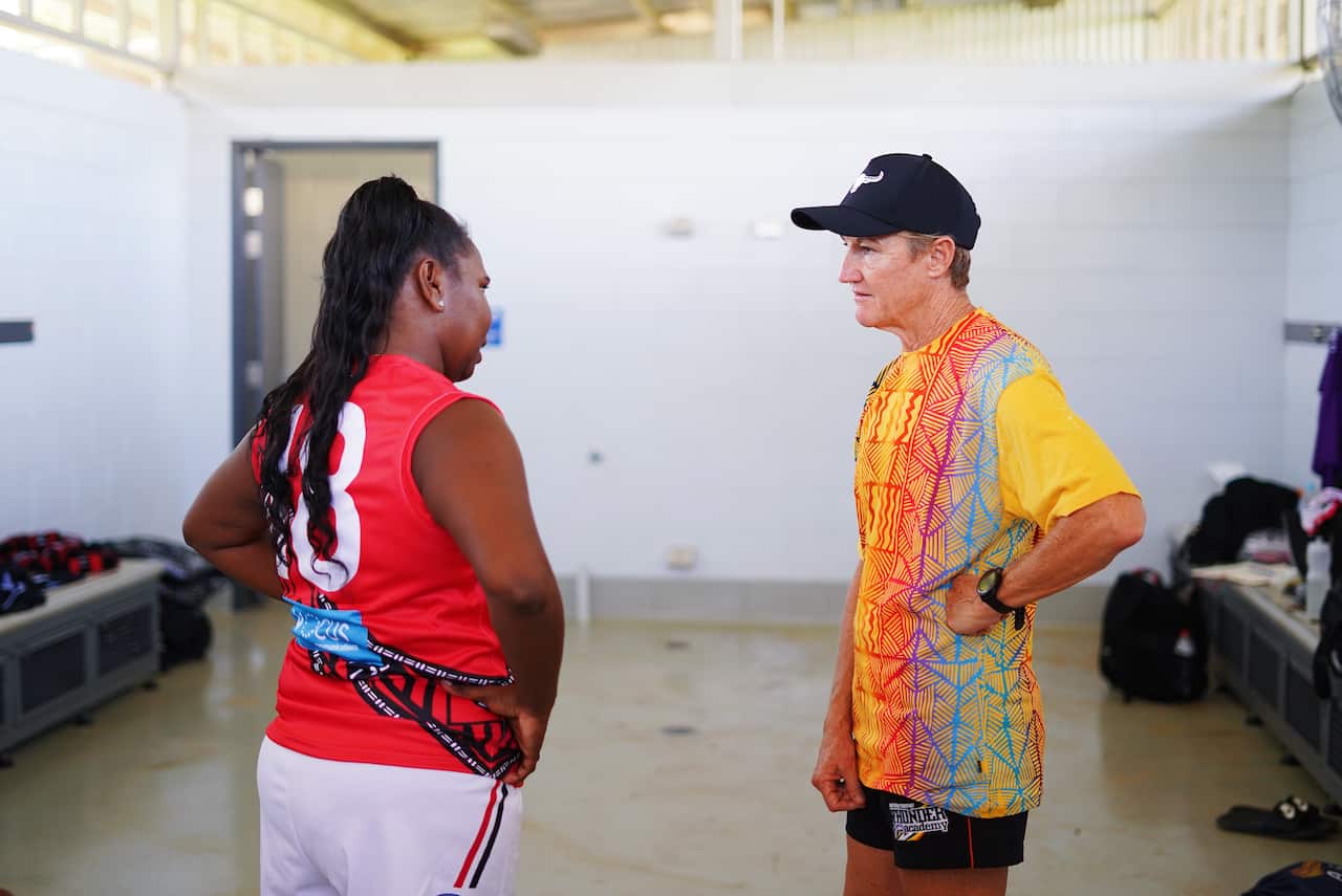 Coach of the women's team, Colleen Gwynne, talks strategy with captain Laelia Dunn.