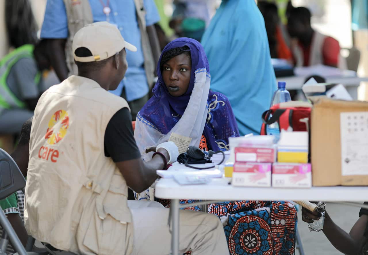 Care Australia worker with woman in Lake Chad Basin