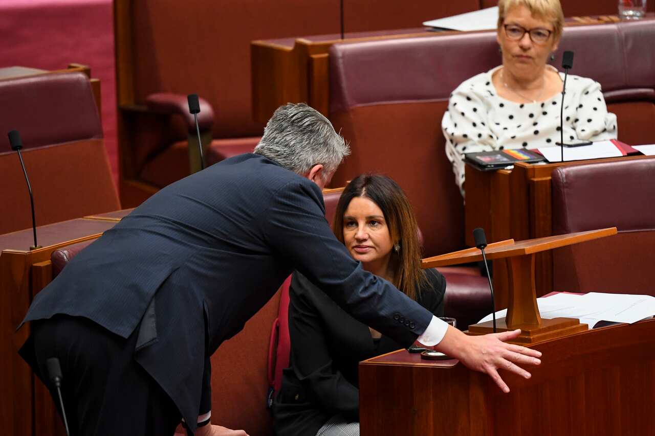 Crossbench Senator Jacqui Lambie (right) speaks with the Leader of the Government in the Senate Mathias Cormann.