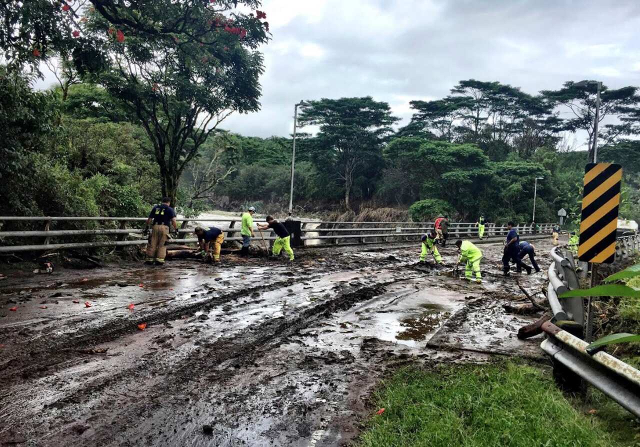 In this photo provided by Jessica Henricks, crews work at clearing damage from Hurricane Lane Friday, Aug. 24, 2018