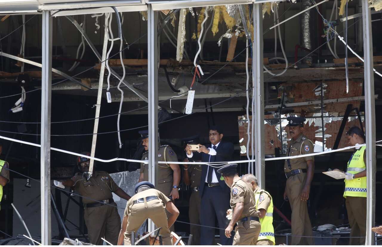 Sri Lankan police investigate the scene after an explosion hit Shangri-La Hotel in Colombo, Sri Lanka.