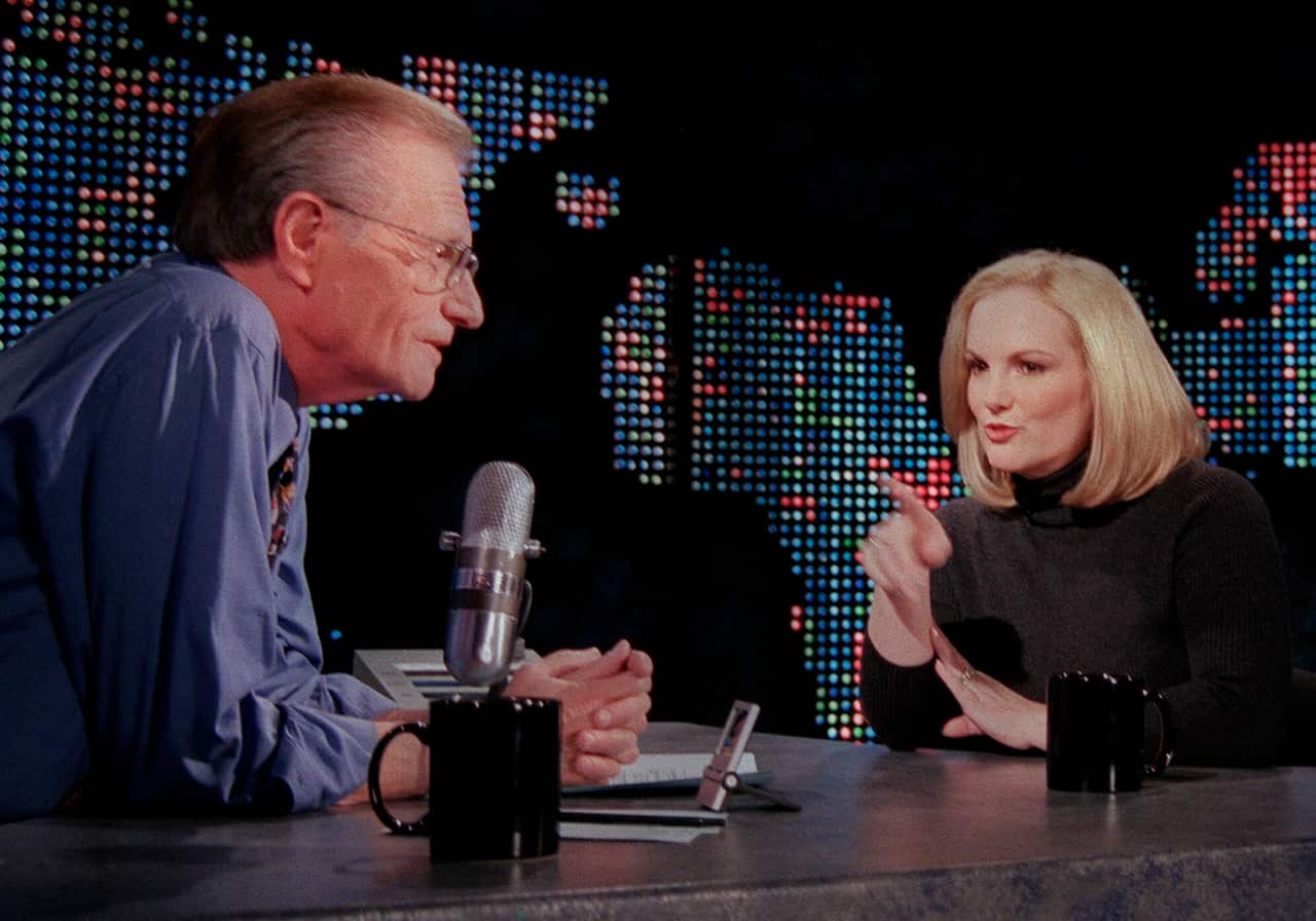 Newspaper heiress Patricia Hearst Shaw gestures toward talk show host Larry King in 2001.  