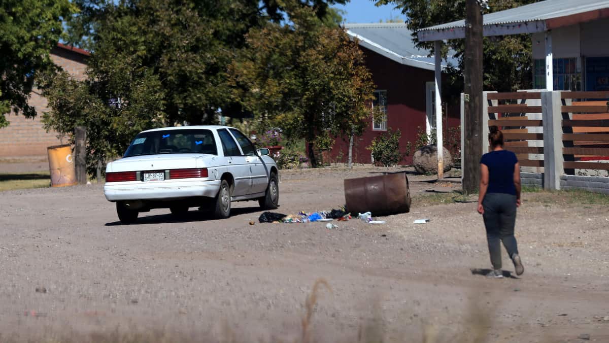 A woman walks by a road in the town of Galeana, Chihuahua state, Mexico on 5 November 2019. 