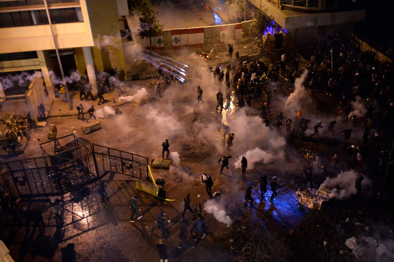 Lebanese riot police shoot tear gas at anti-government protesters during clashes outside of the Lebanese Government palace in downtown Beirut.