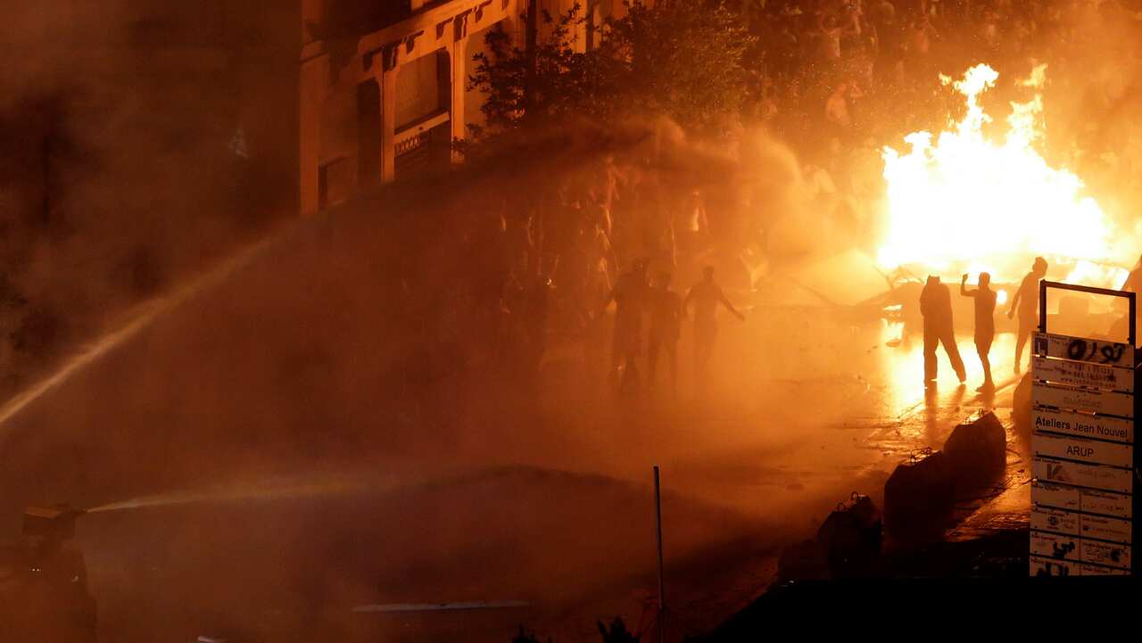 Lebanese riot police use water cannon on anti-government protesters during a protest against government's plans to impose new taxes in Beirut.