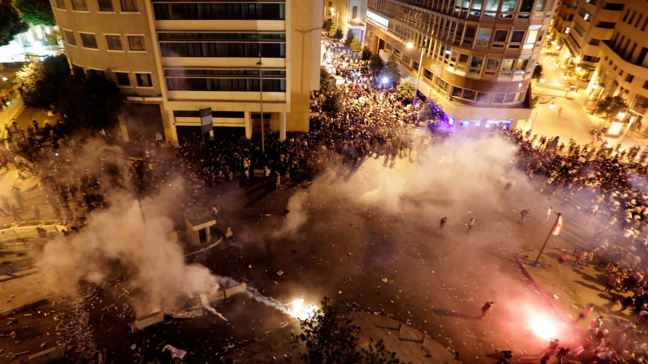 Lebanese riot police fire tear gas during a protest against government's plans to impose new taxes in Beirut.