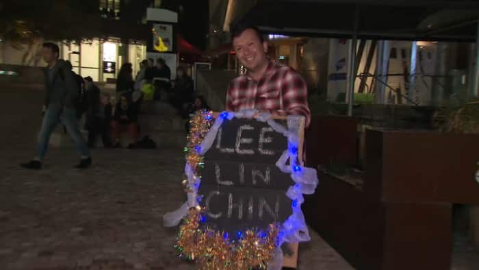Fans watch the bulletin broadcast live at Federation Square.