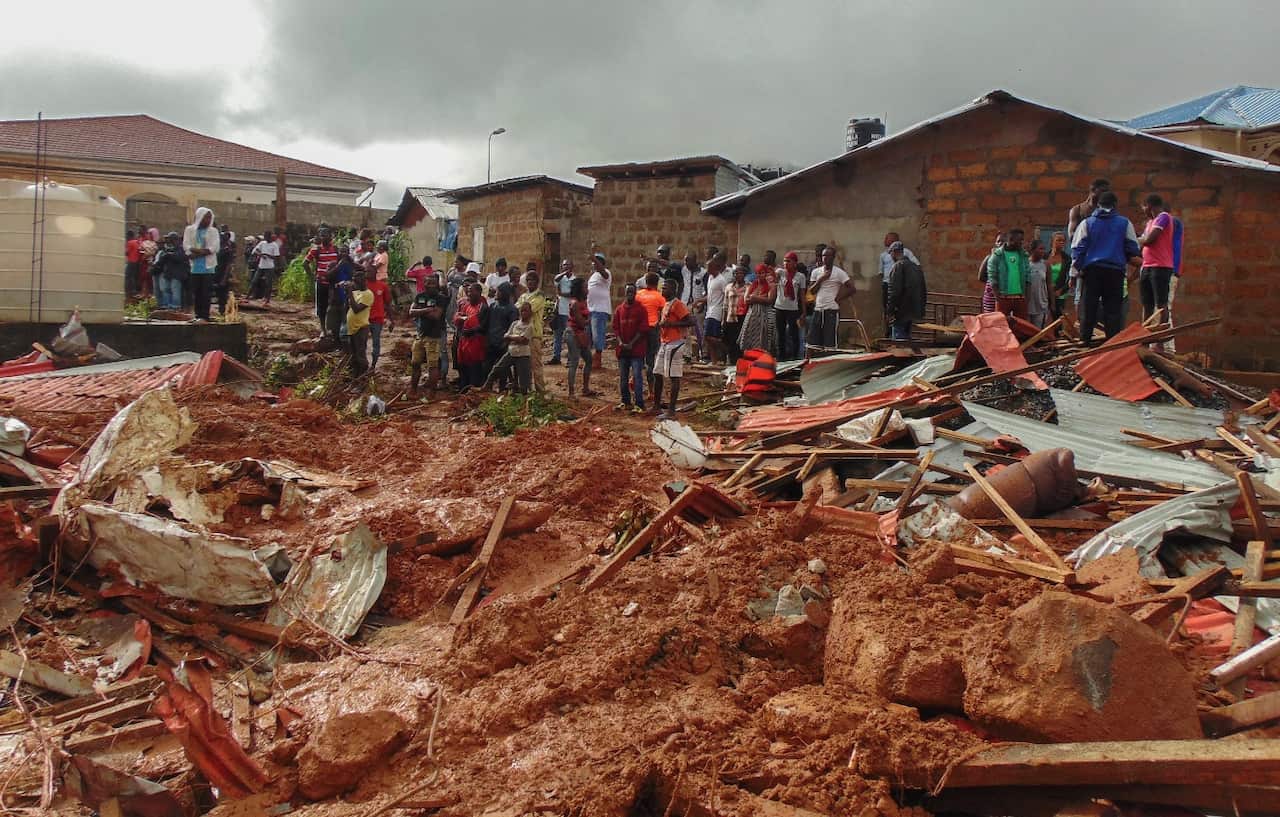 Sierra Leone residents of Freetown view damage to property due to a mudslide in the suburb of Regent behind Guma reservoir, Freetown, Sierra Leone (AAP)