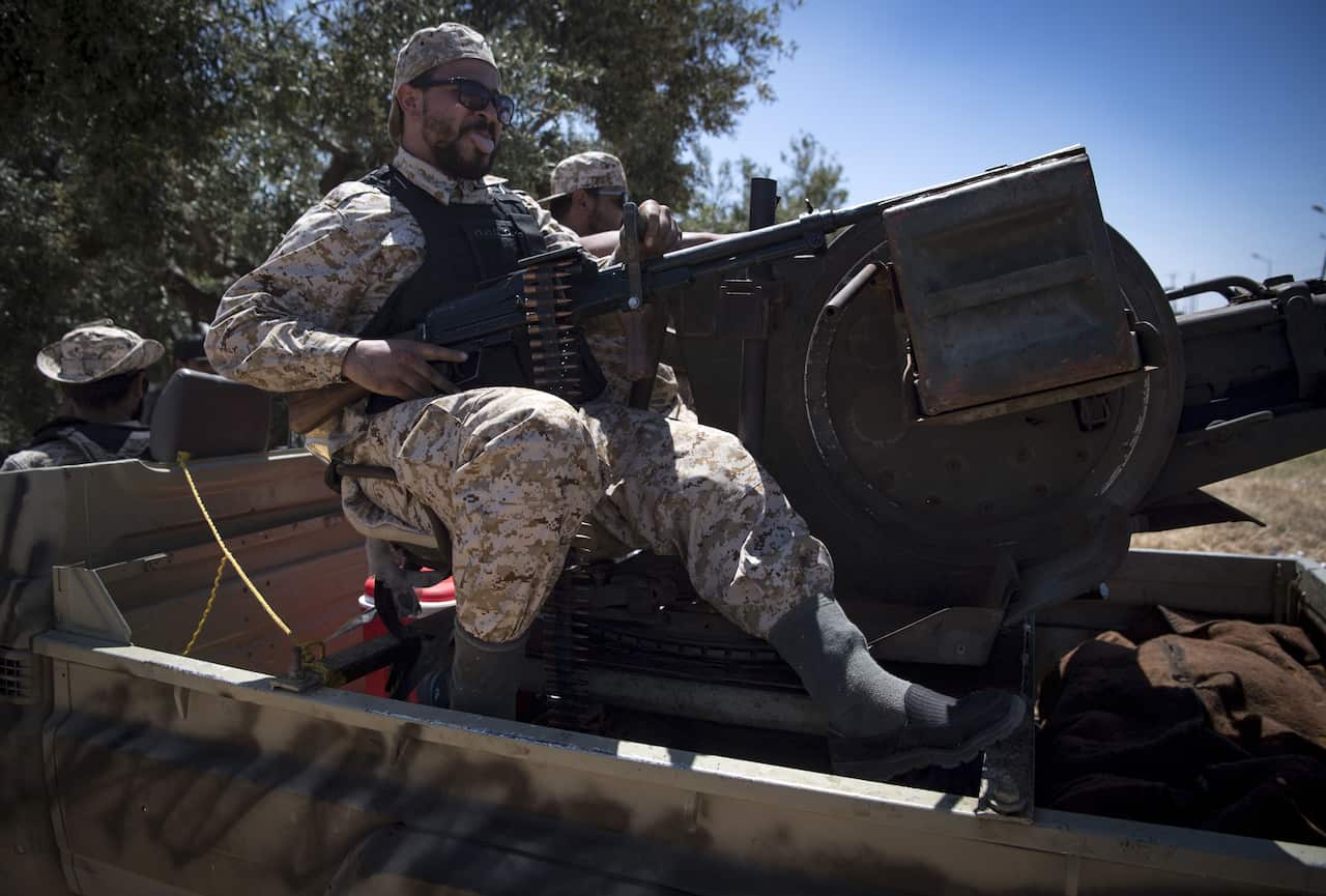 Fighters loyal to the internationally-recognised Government of National Accord (GNA) reacts during clashes with forces loyal to strongman Khalifa Haftar.