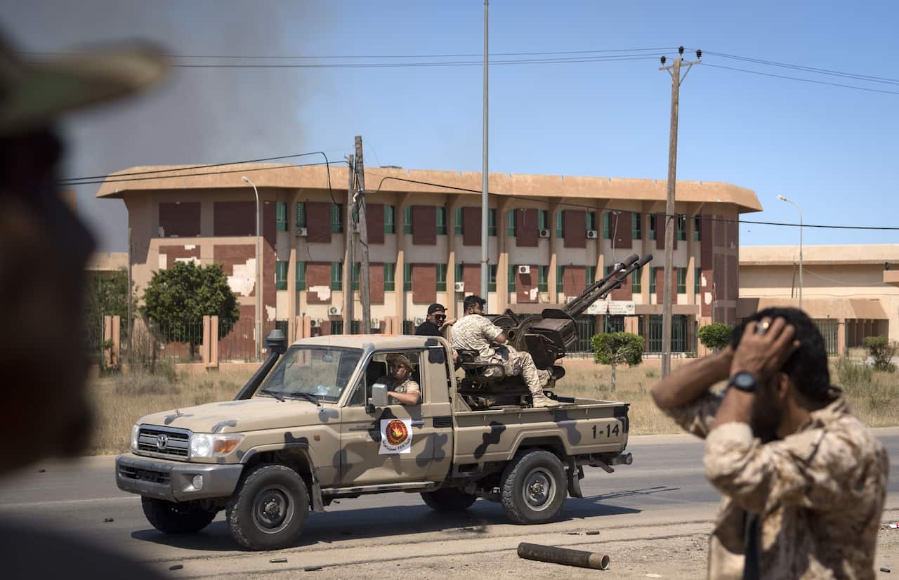 A fighters loyal to the Government of National Accord (GNA) prepares to fire a truck-mounted gun during clashes with forces loyal to strongman Khalifa Hafta.