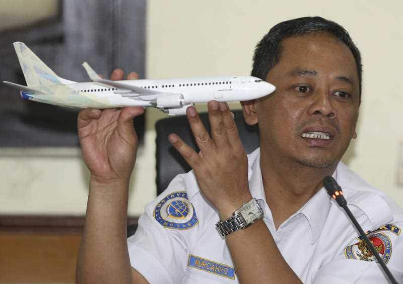 Indonesian National Transportation Safety Committee investigator Nurcahyo Utomo holds a model of a Boeing737 MAX 7 as part of the Lion Air investigation. 