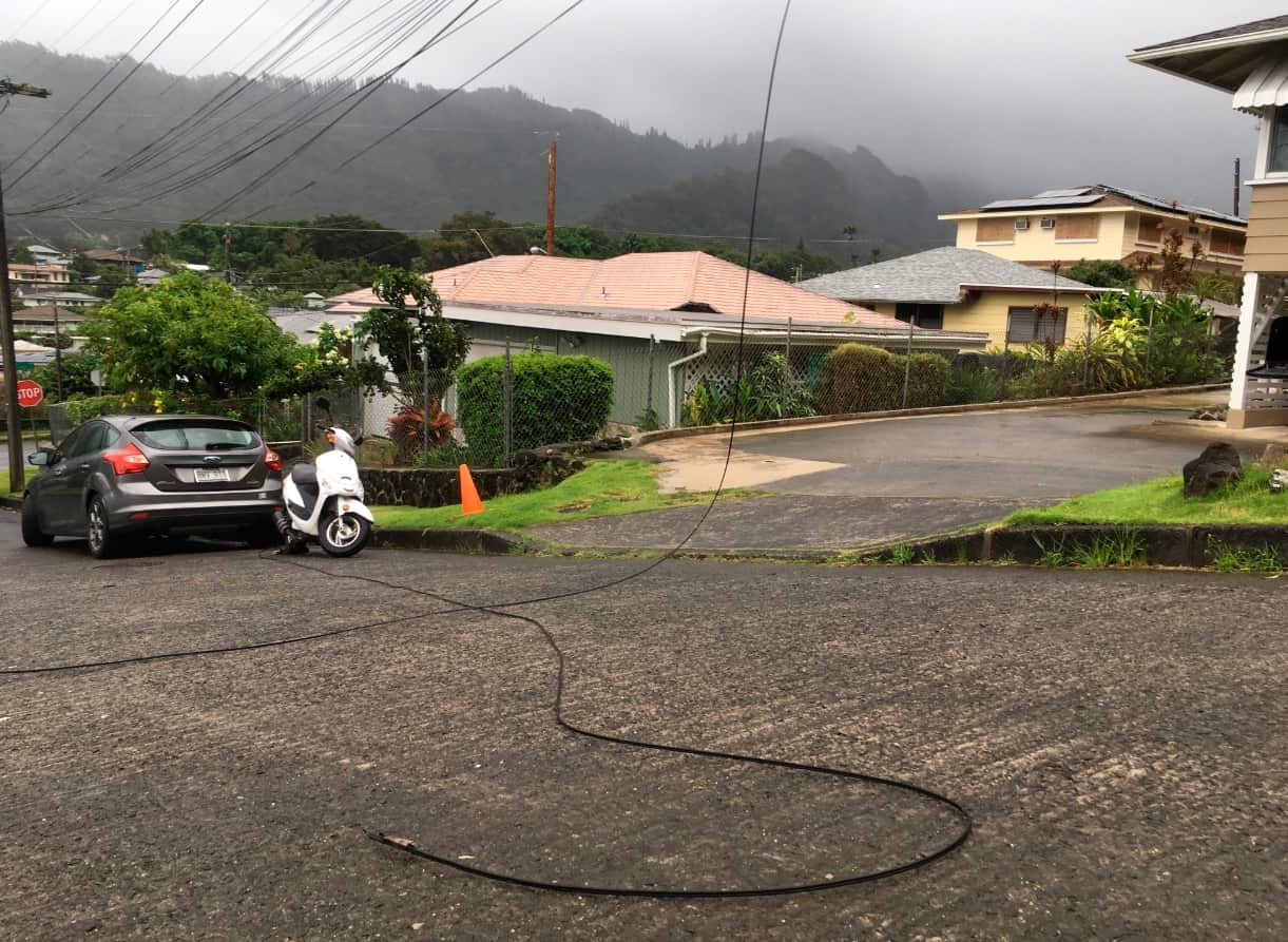 A utility line lays in the street in the Nuuanu neighborhood of Honolulu, Friday, Aug. 24, 2018, as Hurricane Lane approaches.