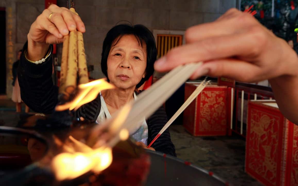 Ethnic Chinese Thais burn joss sticks at the Leng Nuei Yee Chinese temple in Bangkok.