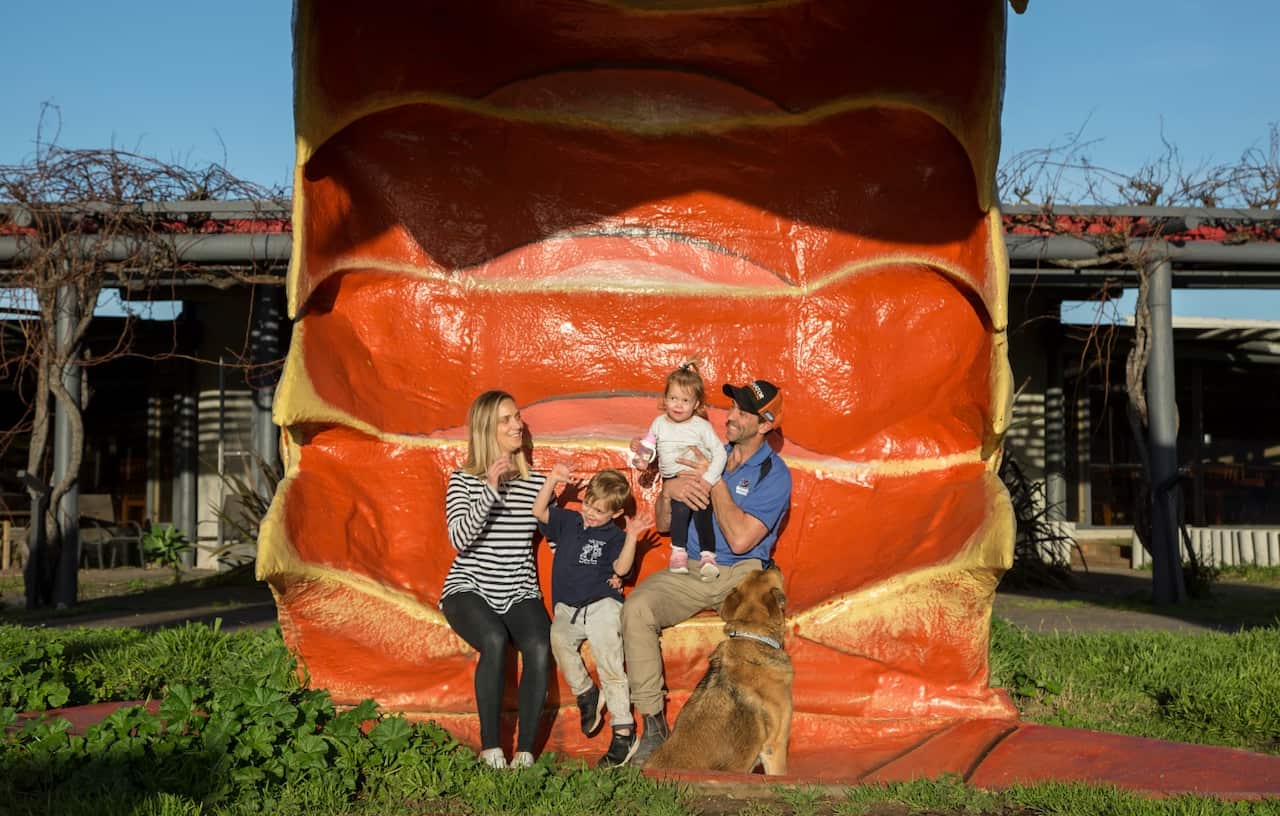 Casey Sharpe, seated at right, with his family in The Big Lobster’s tail in Kingston South East, Australia, Aug. 1, 2018. 