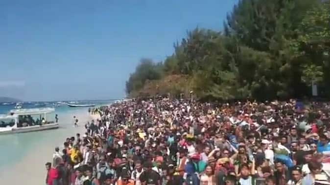 Hundreds pack Lombok beach to evacuate after an earthquake hit the island.