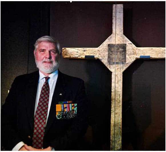 Battle of Long Tan veteran and commander of 12 Platoon, D Company David Sabben with the Long Tan Cross at the Australian War Memorial.