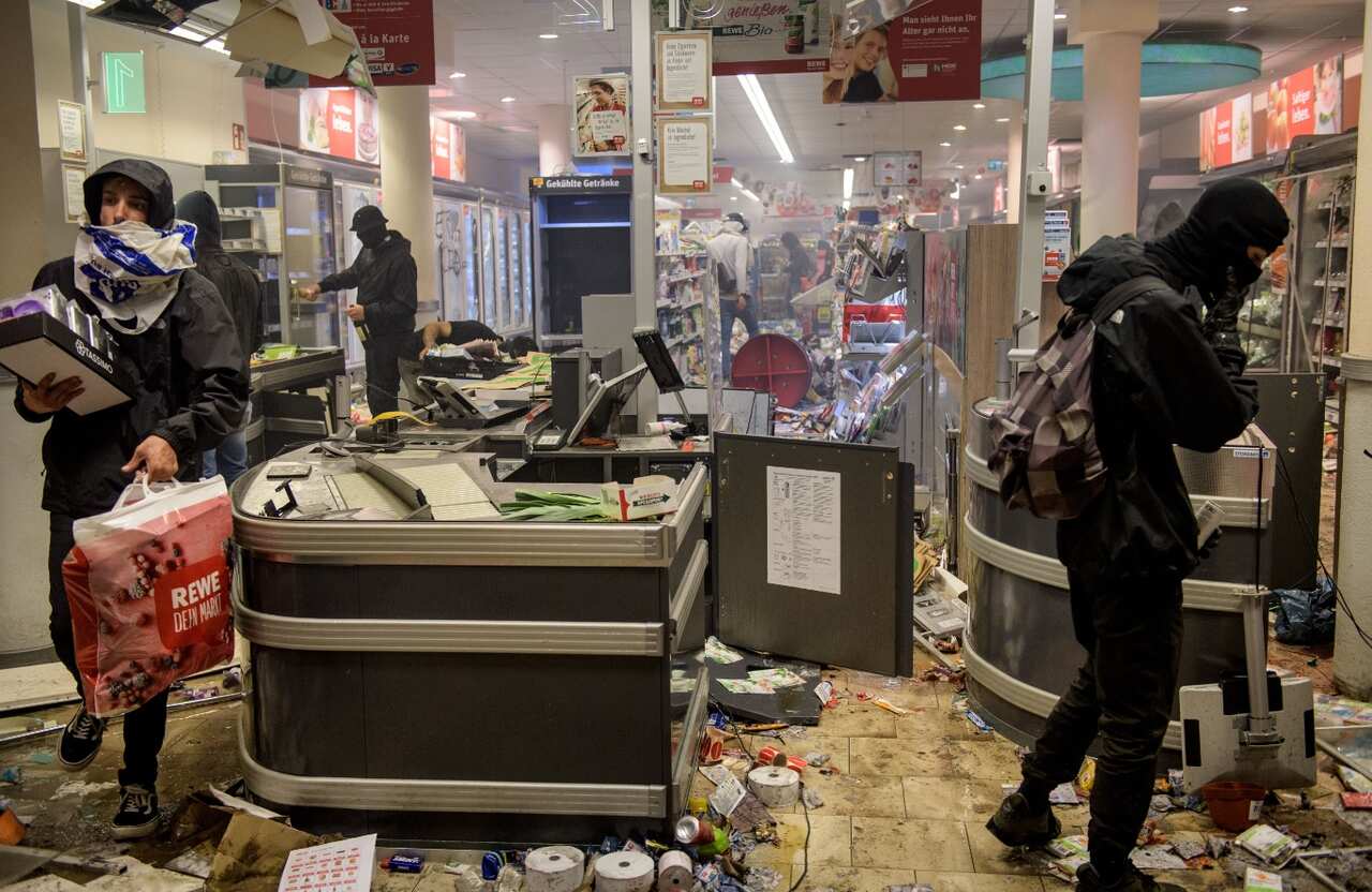 Protesters against the G20 Summit plunder and destroy a Rewe supermarket in the Schanzenviertel district on July 7, 2017 in Hamburg