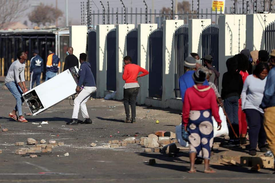 Demonstrators loot a shopping centre during protests following the imprisonment of former South Africa President Jacob Zuma, in Katlehong, South Africa.