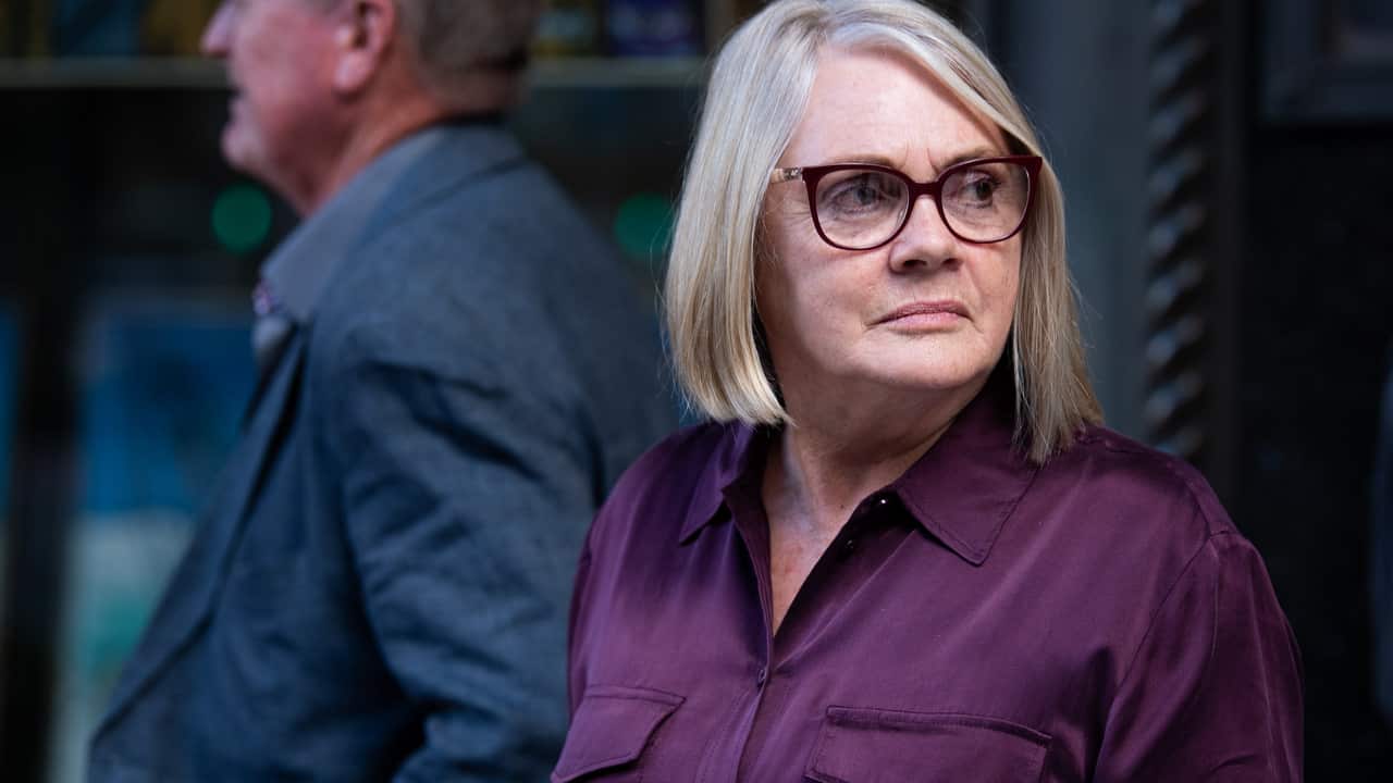 Lorraine Cross and her husband Peter, victims of Hamish McLaren, leave the Downing Centre District Court.