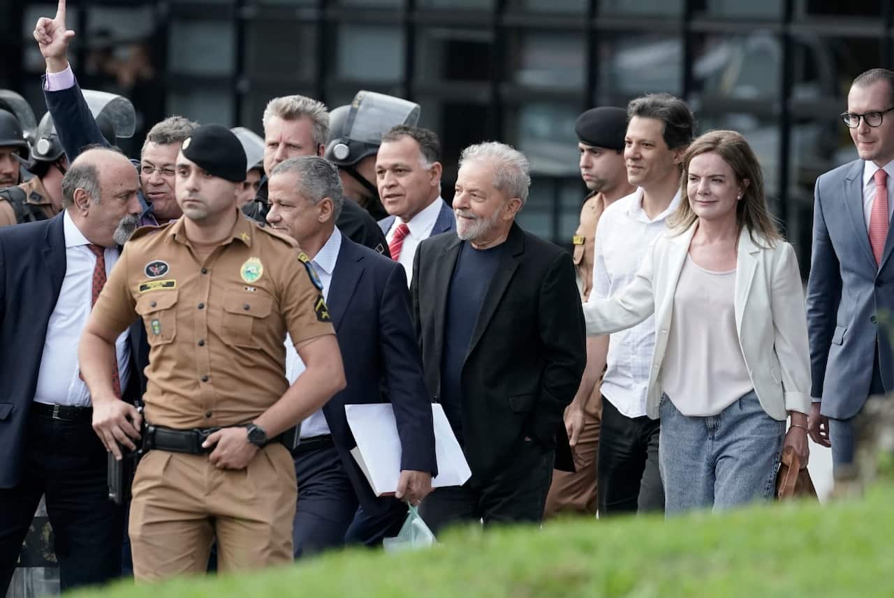 Brazil's former President Luiz Inacio Lula da Silva, center, exits the the Federal Police headquarters 