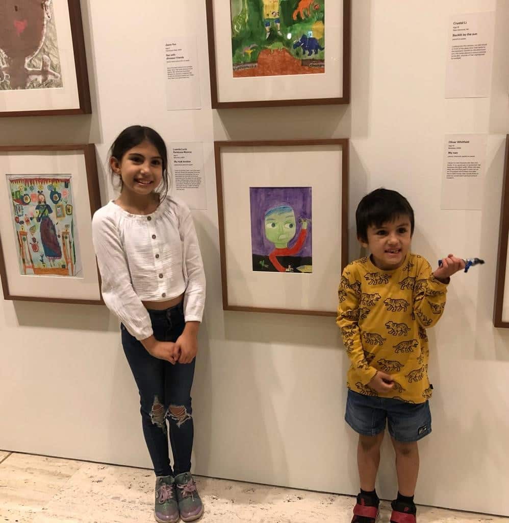 Lucia Perlstone Monroy with her younger brother recreating her winning portrait in the 9-12 yrs category.